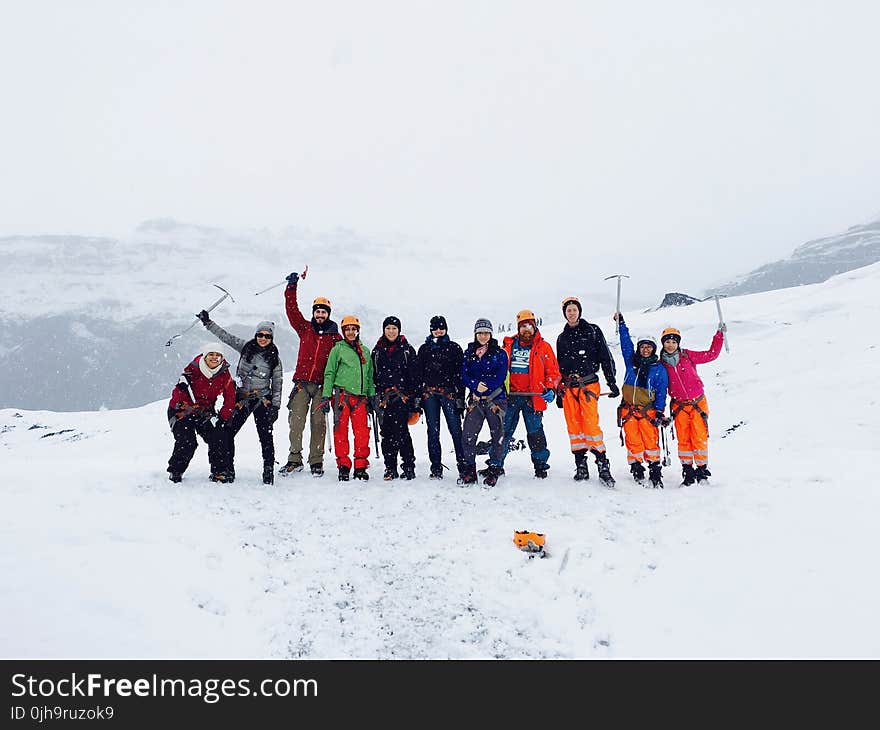 Men and Women at the Mountain Covered With Snow