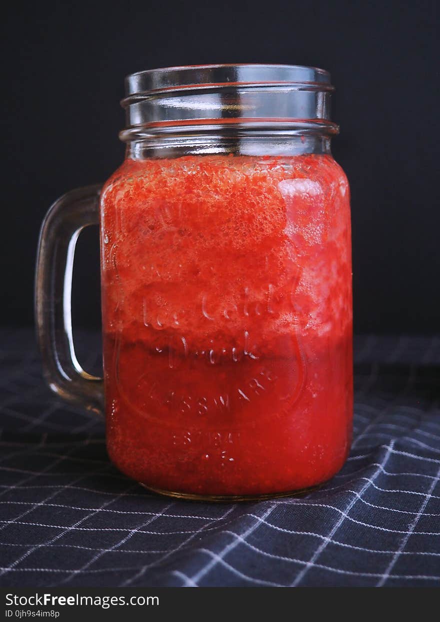 Clear Glass Mason Mug Filled With Red Liquid