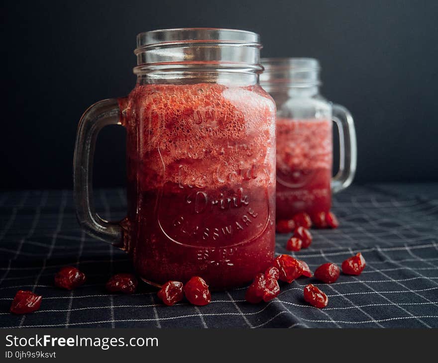 Mason Jar Filled With Cranberry Juice On Black and White Checked Cloth