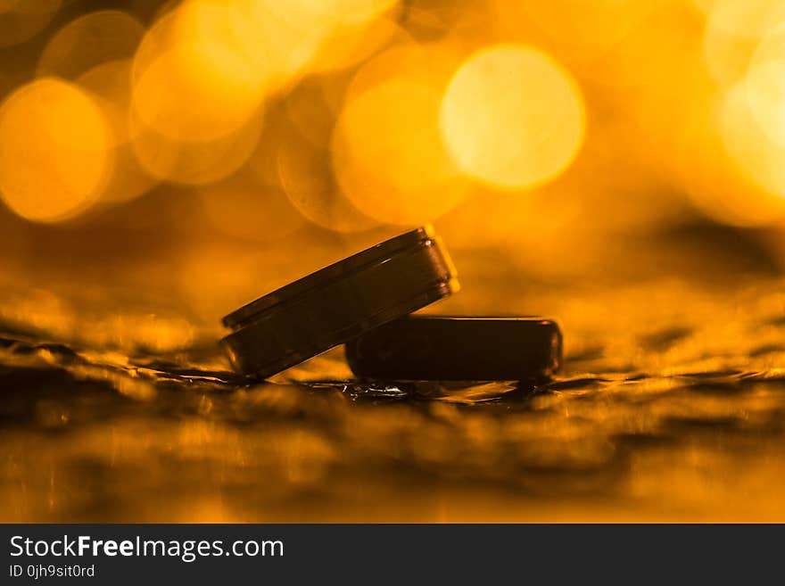 Pair of Silver Wedding Rings in Shallow Focus Photography