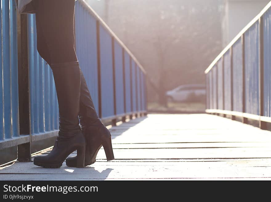 Woman Standing on Bridge