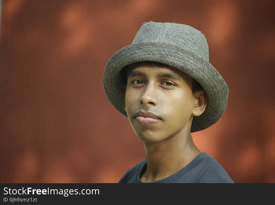 Selective Focus Photography of Man Wearing Gray Fedora Hat and Gray Crew-neck Shirt