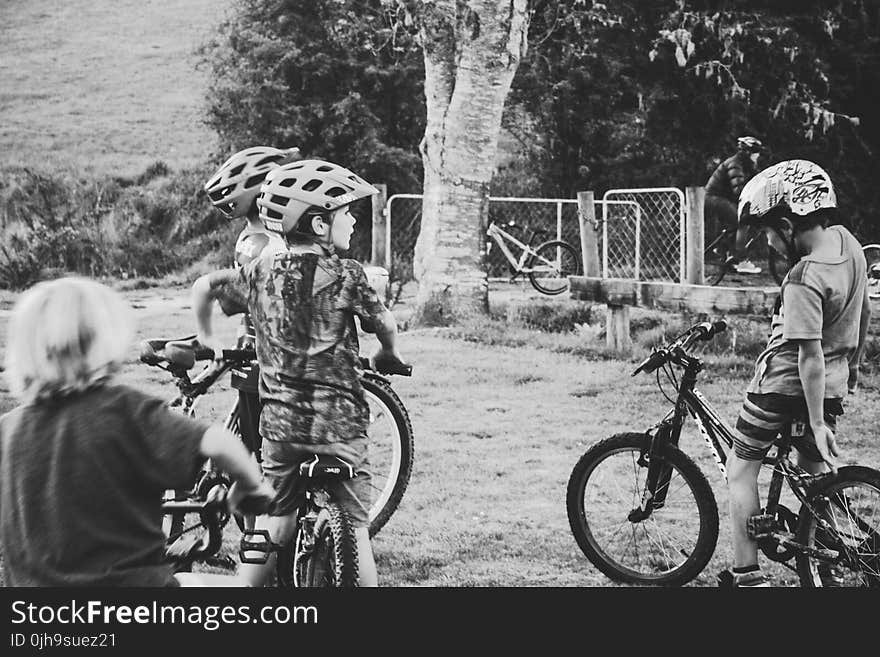 Grayscale Photography of Children Riding Bicycles