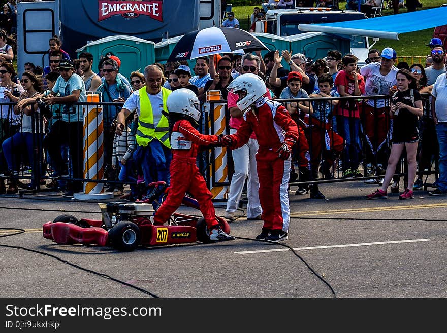 Two Boy in Red and White Racing Costume