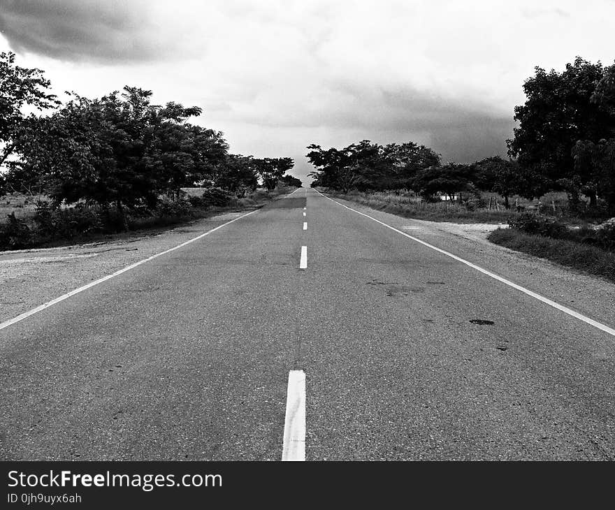 Grayscale Photography of Concrete Road during Daytime