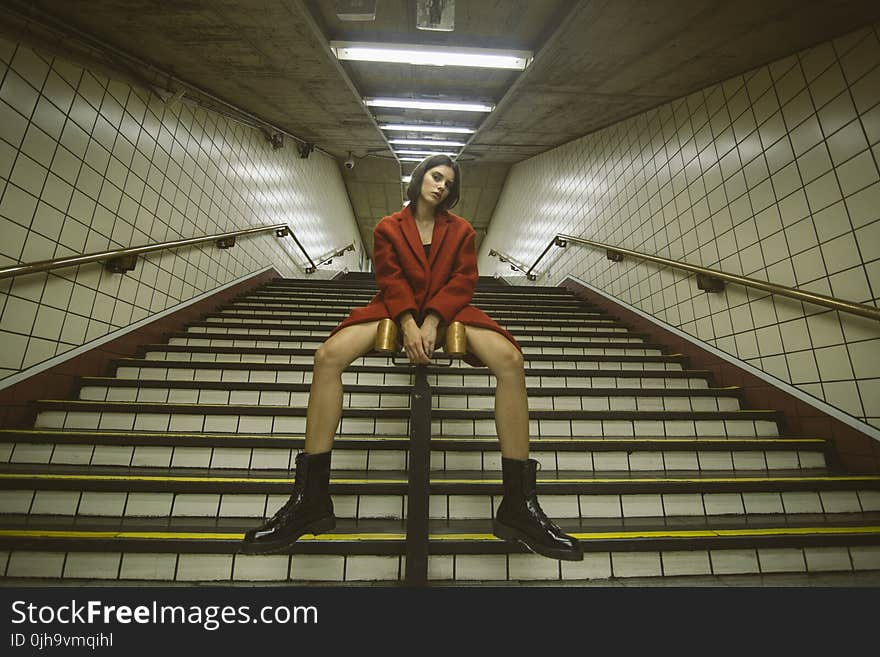 Woman Sitting on Handrail With Both Hand on Front