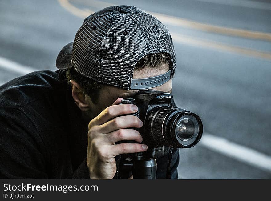 Man Taking Photo Using Black Canon DSLR Camera