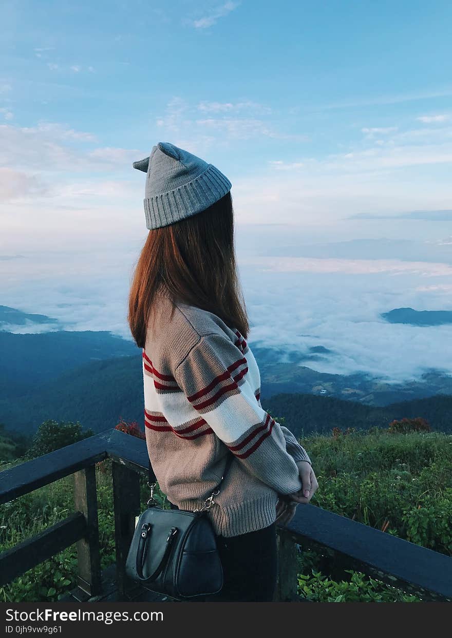 Standing Woman Wearing White and Gray Sweater