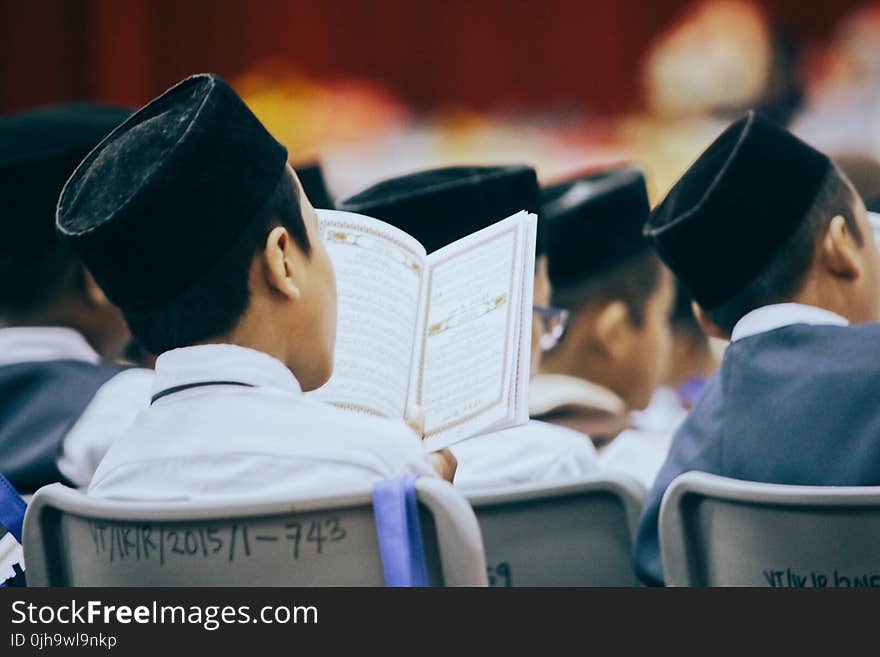 People Sitting on Chair Reading Books