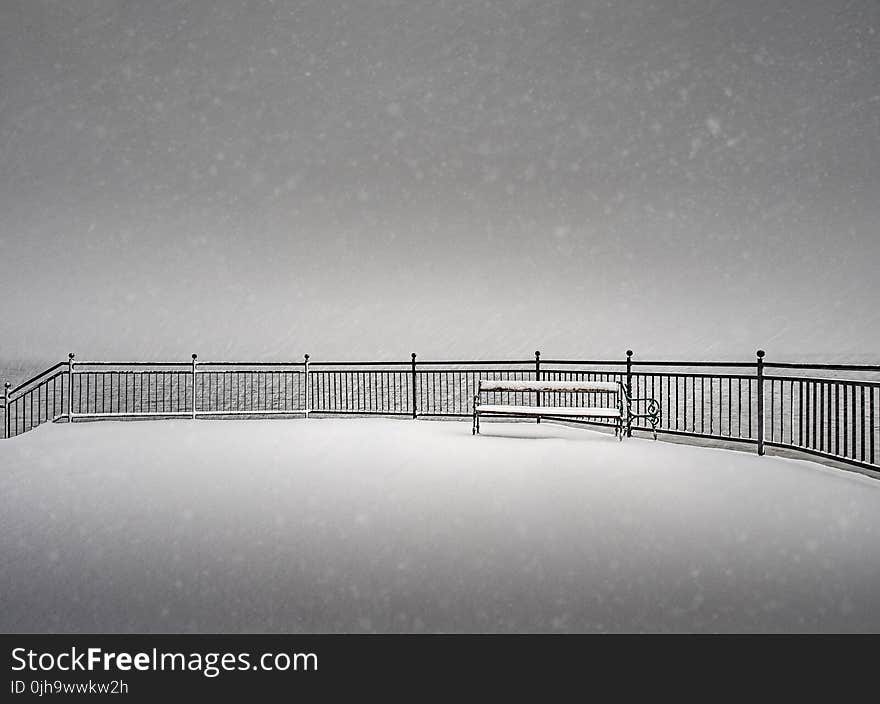 Snow Covered Bench on a Snowy Day