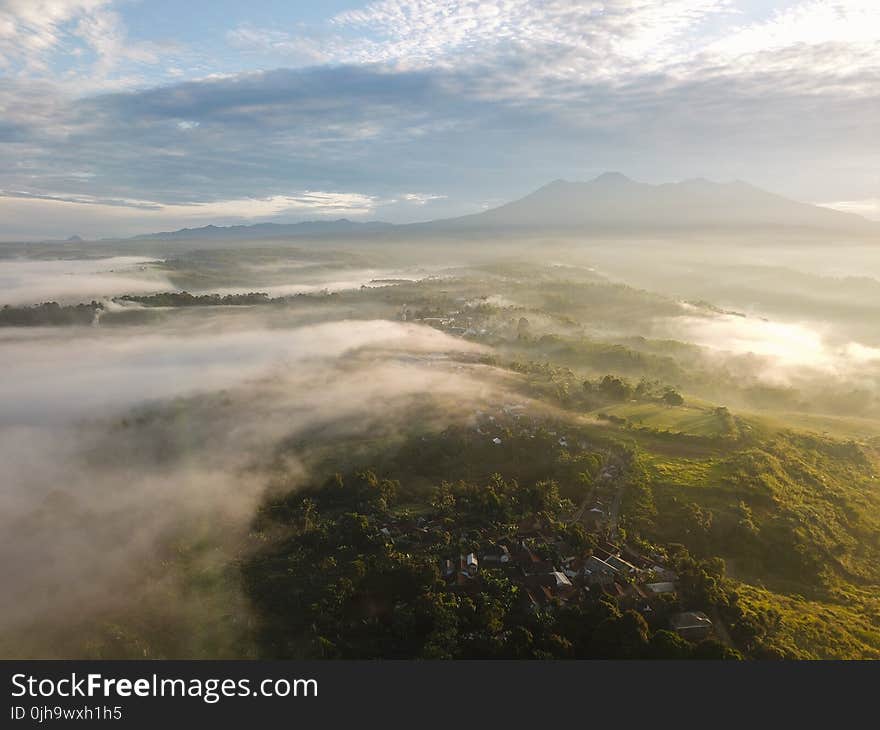 Aerial Photography of Green Mountains and Trees Under Sunny Sky