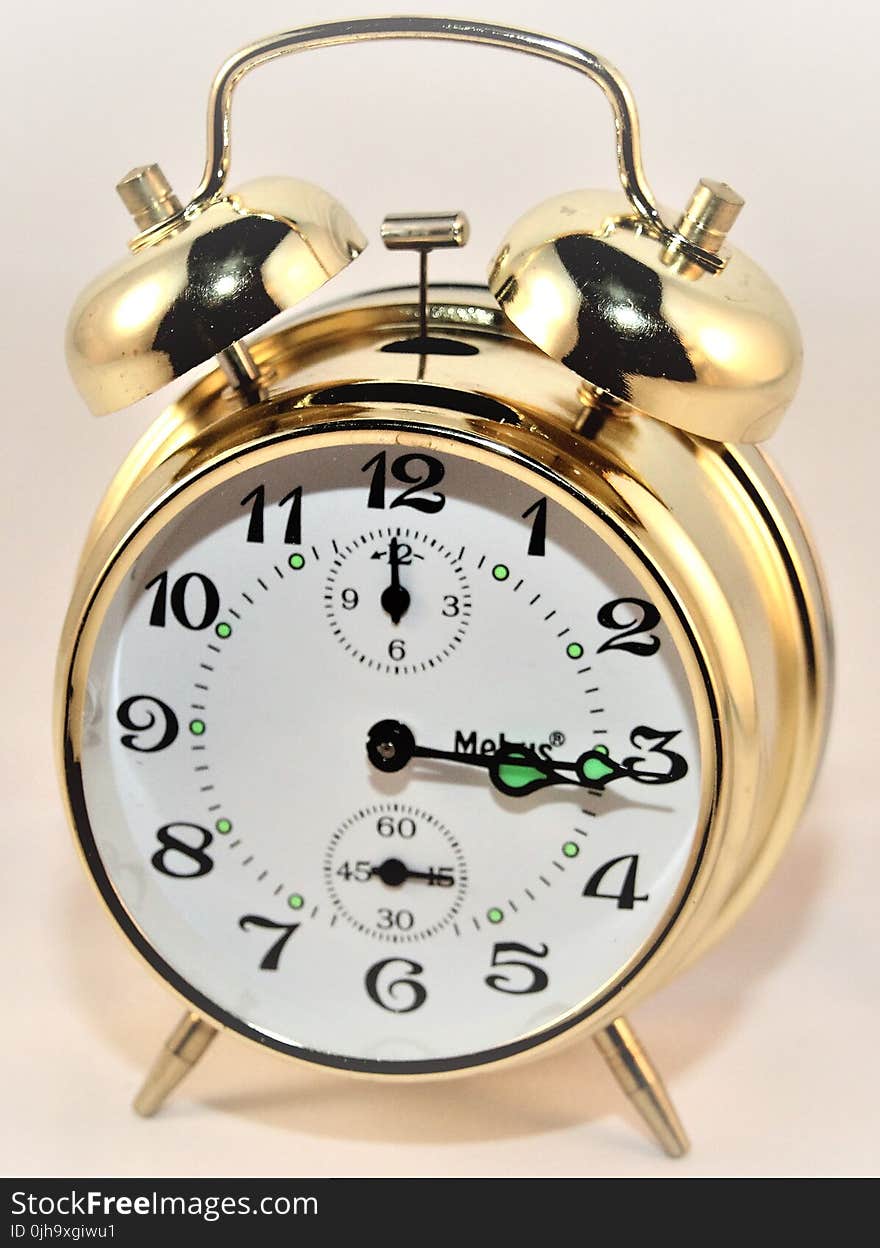 Brass-colored Alarm Clock at 3:15