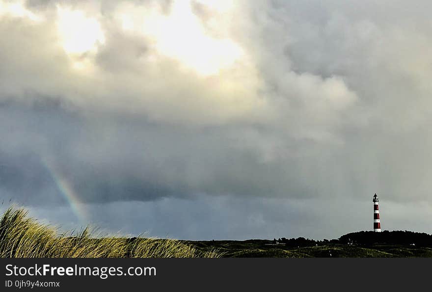 White and Red Lighthouse on Far Right and Rainbow on Far Left