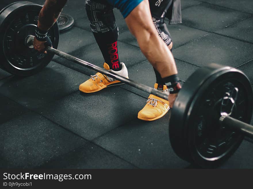 Person About to Start Lifting the Barbell Inside the Gym