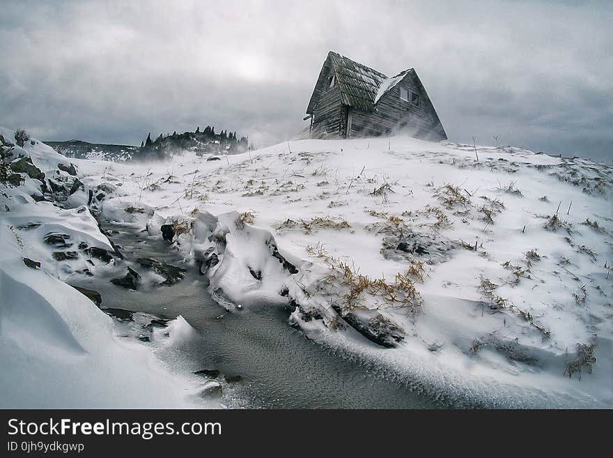 Gray House Surrounded by Snow