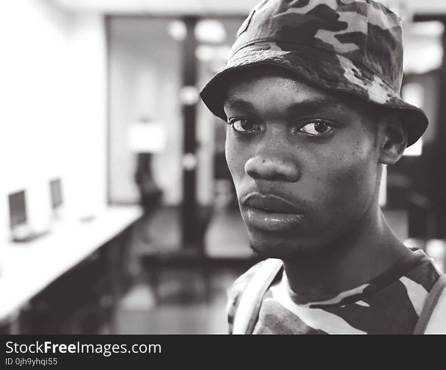 Man Wearing Camouflage Crew-neck T-shirt and Hat