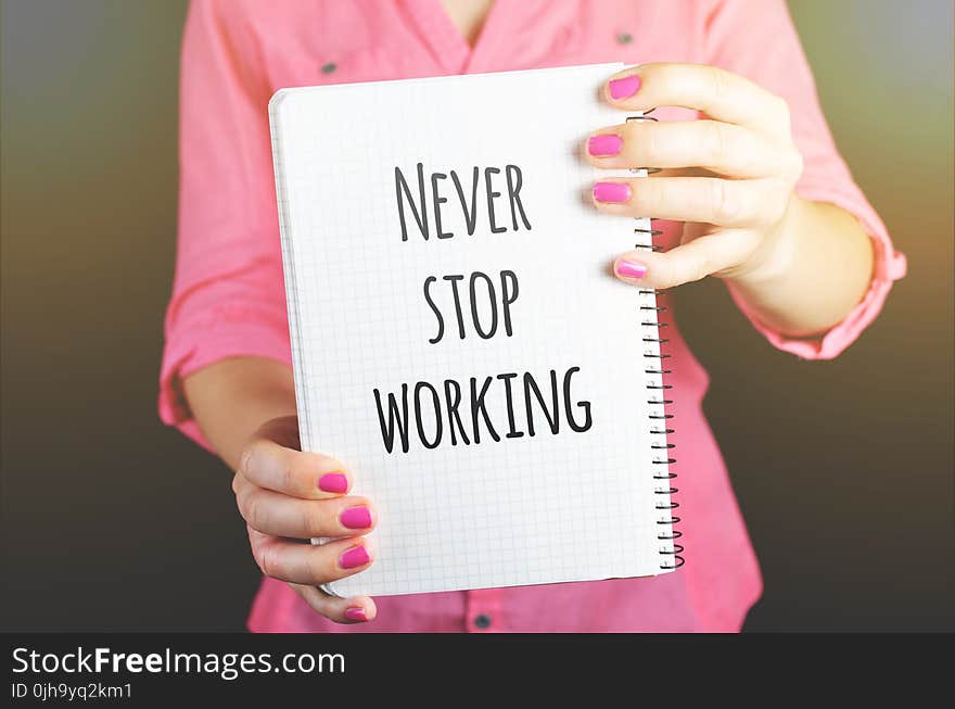 Woman Holding Never Stop Working Print Notebook