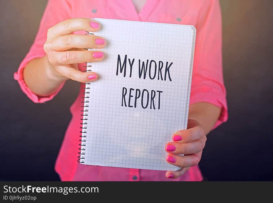 Woman in Pink Long-sleeved Shirt Holding White Book With My Work Report Text Print