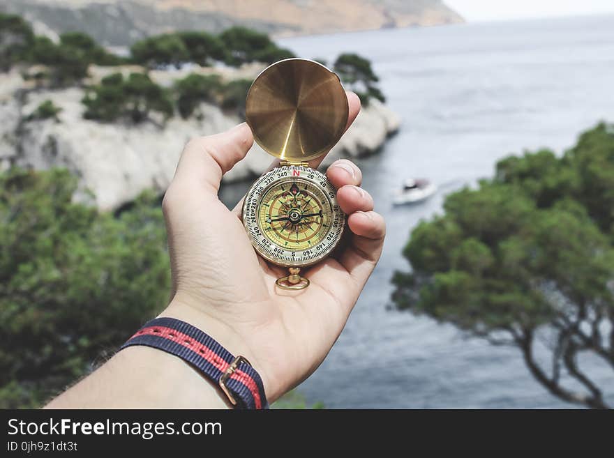 Person Holding Compass