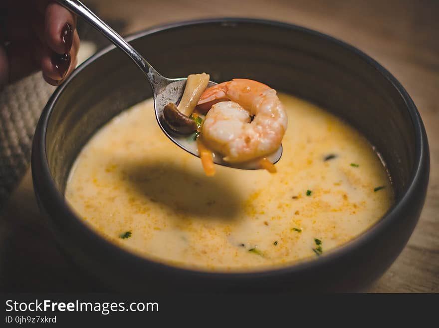 Bowl of Shrimp Soup on Brown Wooden Surface