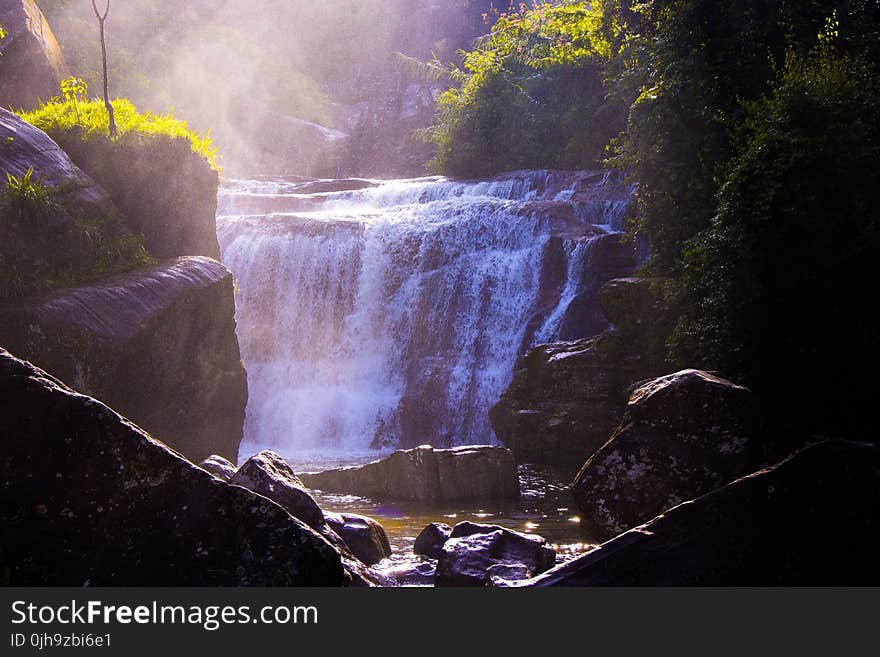 Waterfalls Surrounded by Grass and Rocks