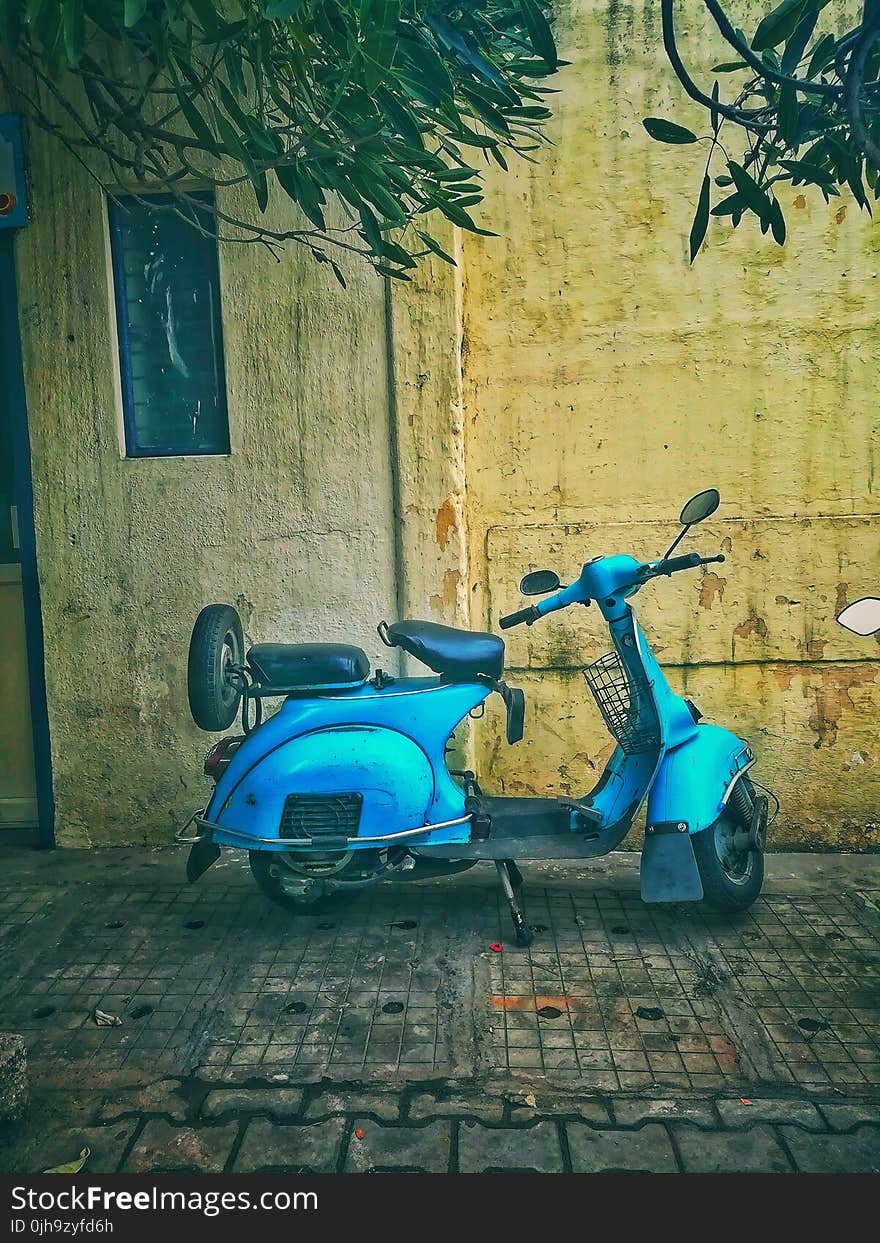 Teal Motor Scooter on Road