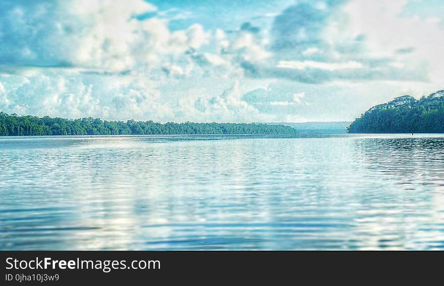 Calm Lake Under Cloudy Sky