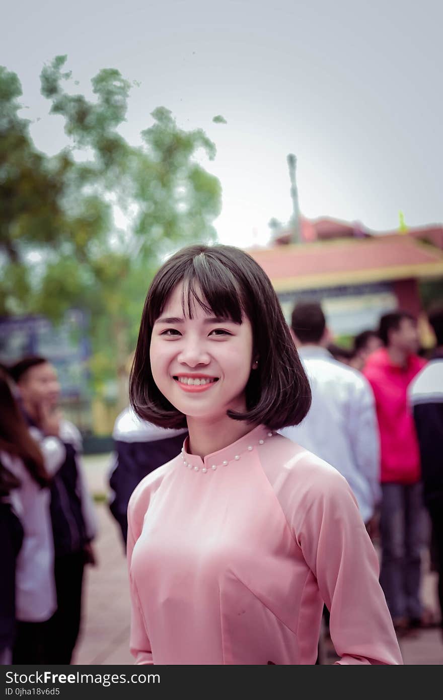 Photography of a Woman in Pink Long-sleeved Top Smiling