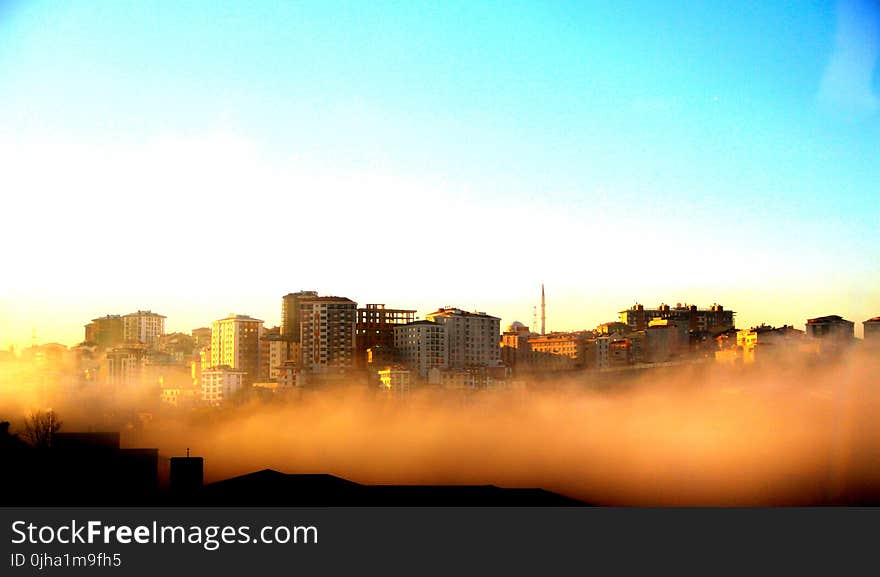 Photography of Buildings on a Foggy Morning