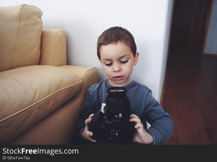 Boy Holding Black Dslr Camera