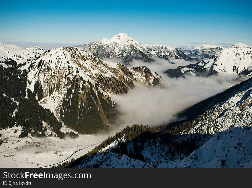 Rocky Mountain With Fog in Daytime Photo