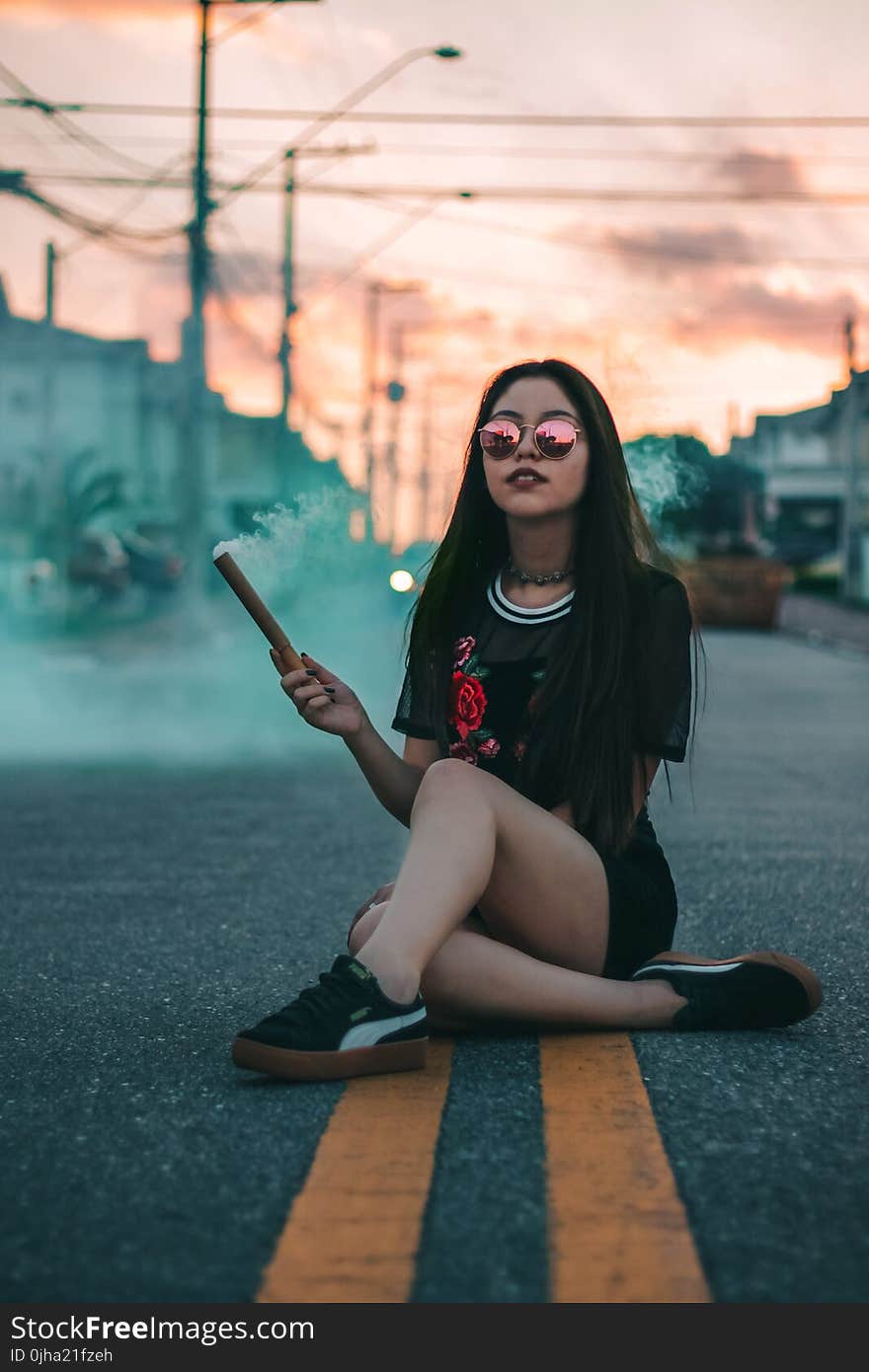 Woman In Black Crew-neck T-shirt Sitting On Concrete Roadway