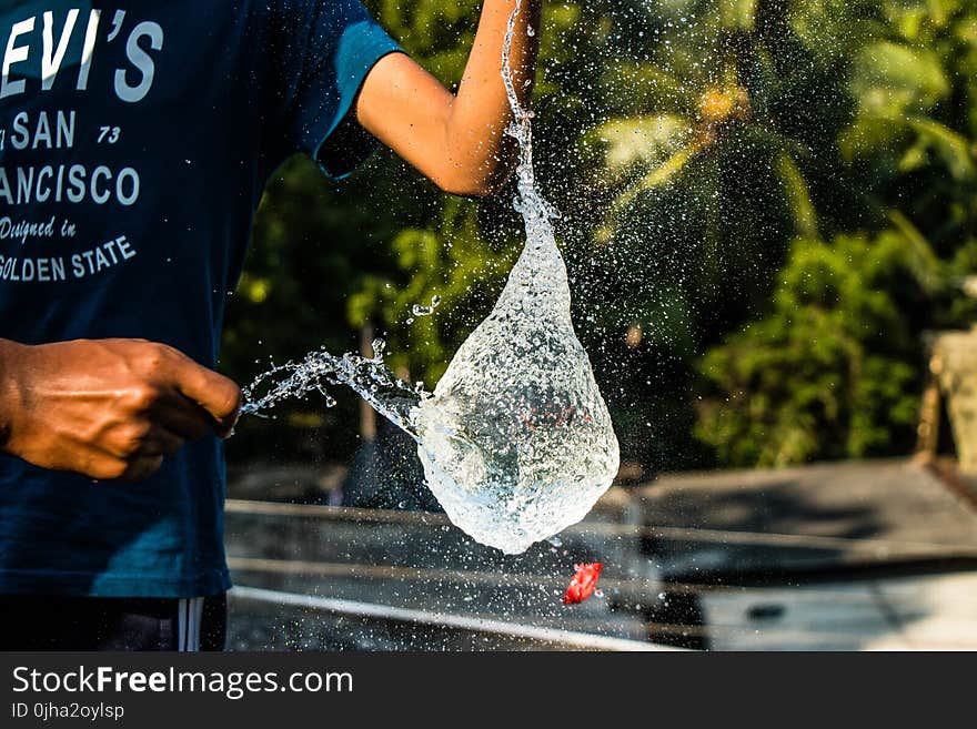 Person in Black Shirt Pouring Water