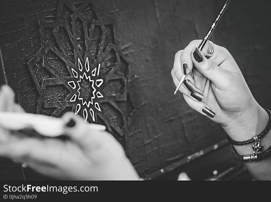 Black and White Photo of Hands Holding a Paintbrush