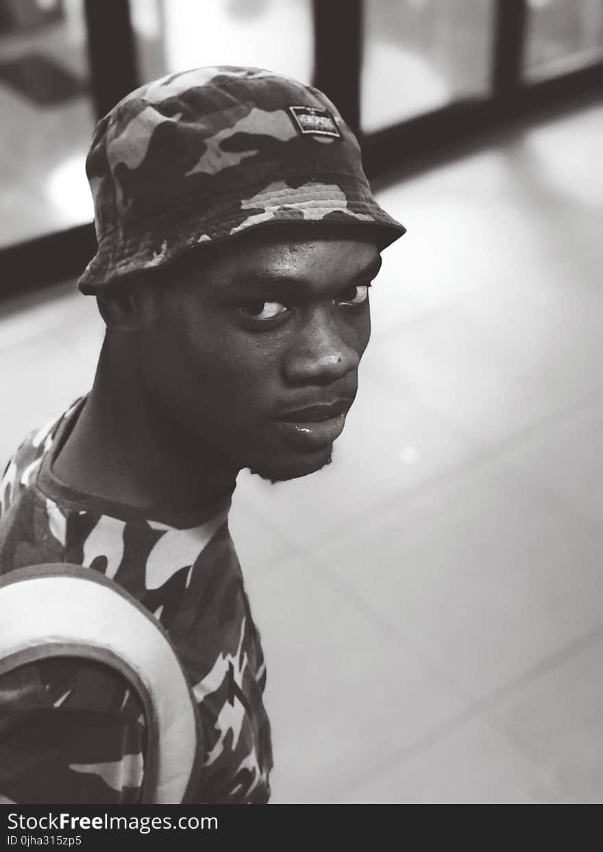 Monochrome Photo of a Man Wearing Camouflage Shirt