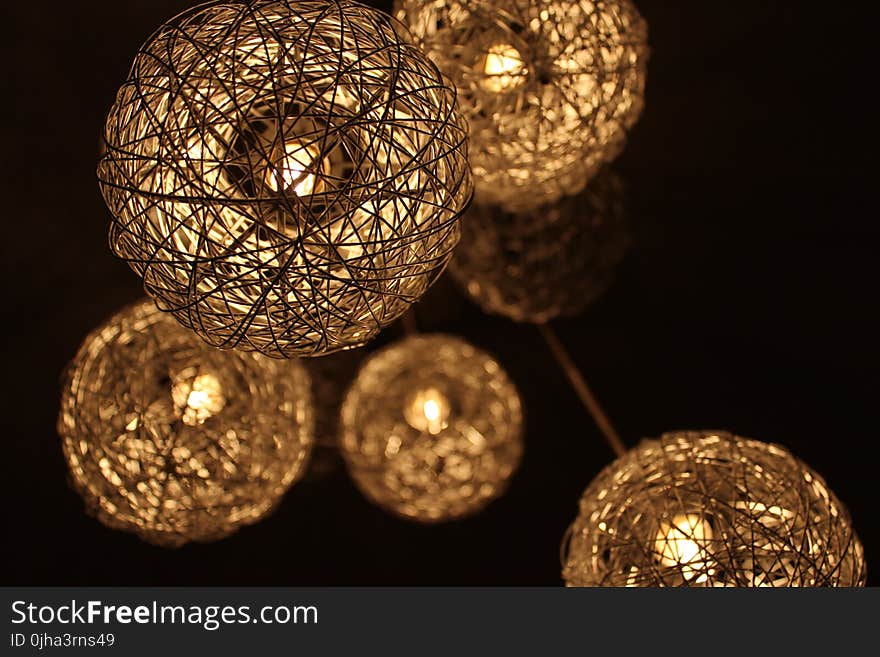 Closeup Photo of Brown Round Twig Pendant Lamps