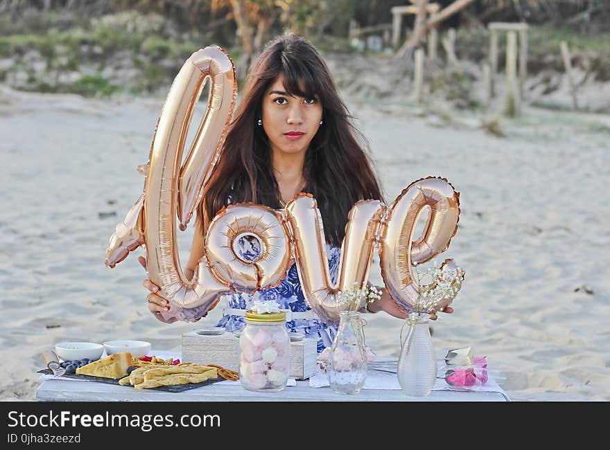 Woman Holding Gold Foil Balloons