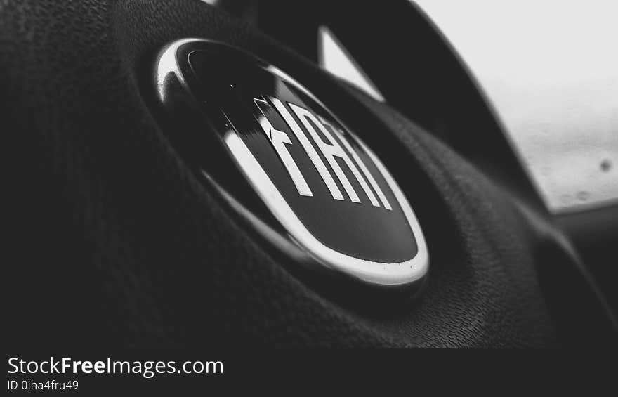 Greyscale and Closeup Photograph of Fiat Steering Wheel