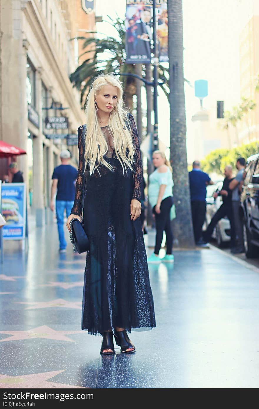 Woman in Black Long Dress Standing on the Pavement