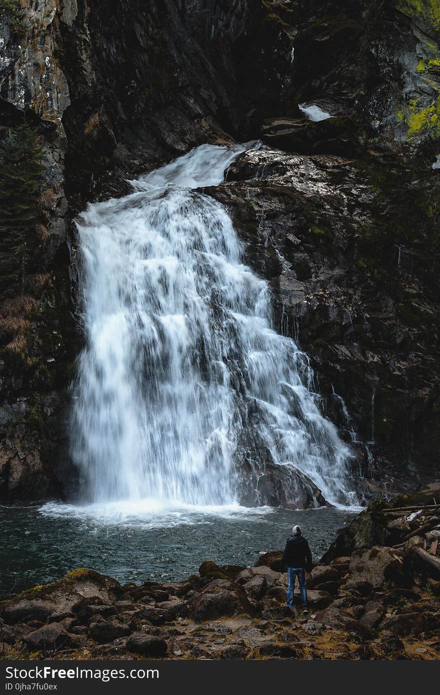 Man Standing Near Waterfalls