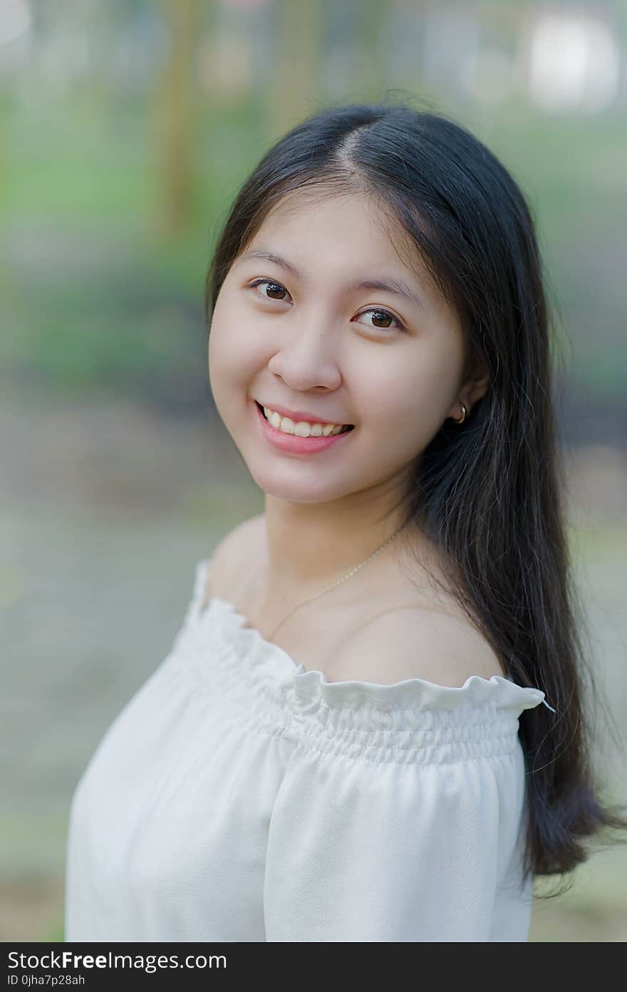 Smiling Woman in White Off-shoulder Tops