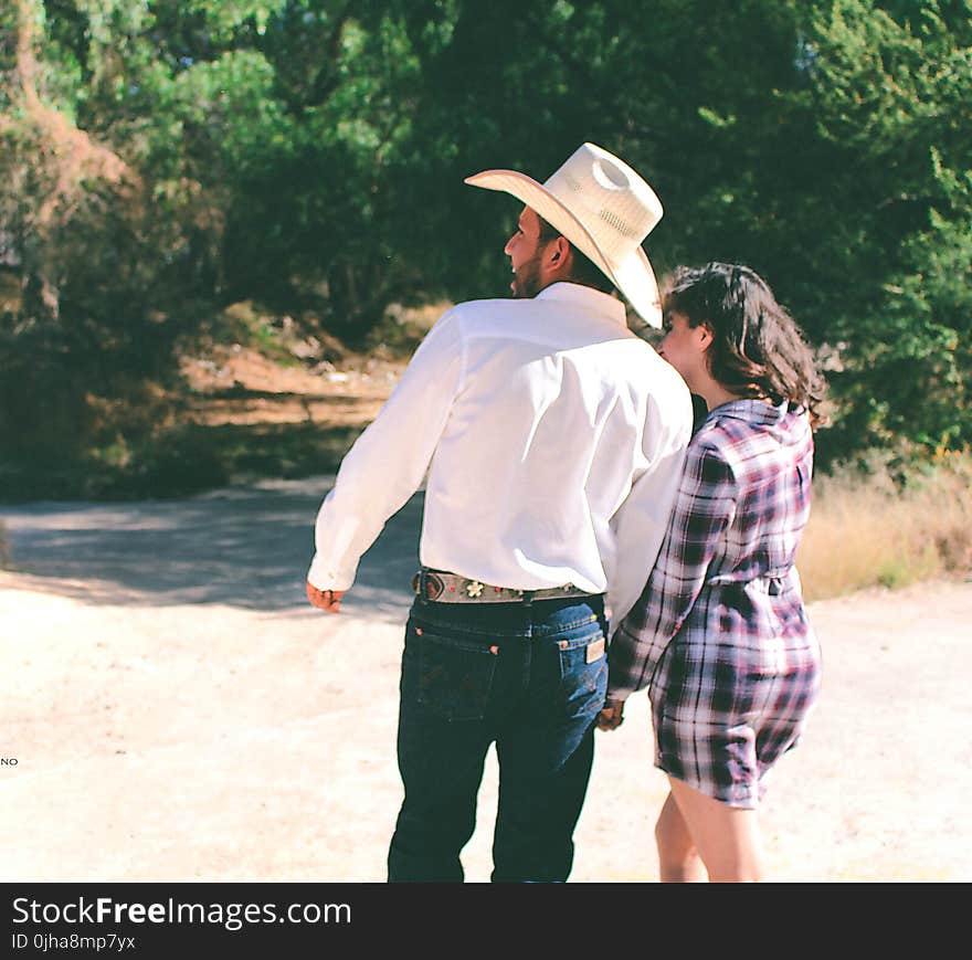 Man Wearing White Dress Shirt And White Cowboy Hat