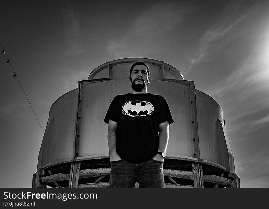 Man in Batman Print Shirt Stand Against Container