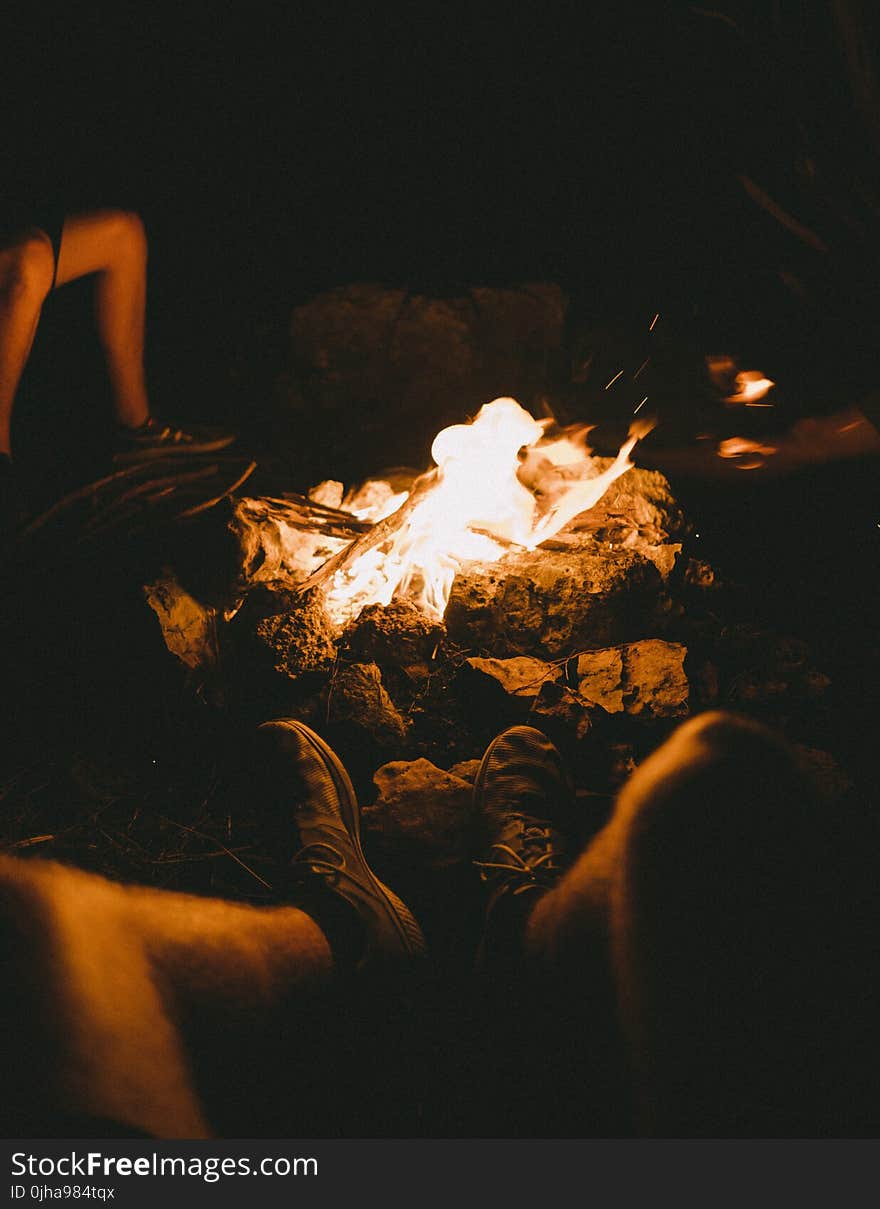 Group of People Sitting Beside the Bonfire during Night Time