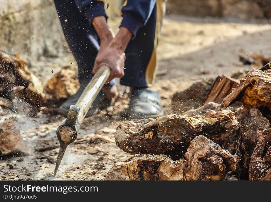 Person Smashing Pick Axe On Ground