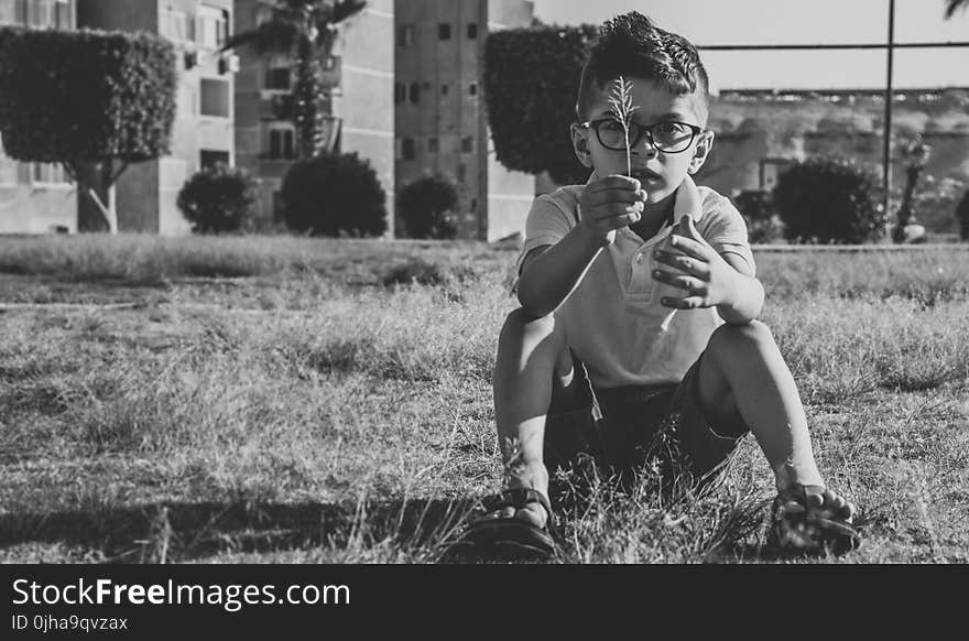 Greyscale Photo Of Boy Wearing Eyeglasses