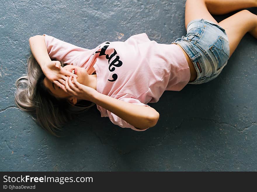 Woman Wearing Pink Printed Crew-neck T-shirt and Blue Faded Denim Shorts