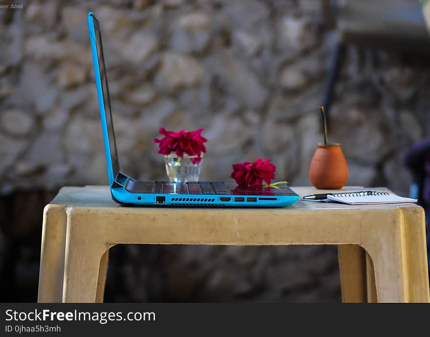 Blue Laptop Computer On Brown Plastic Table