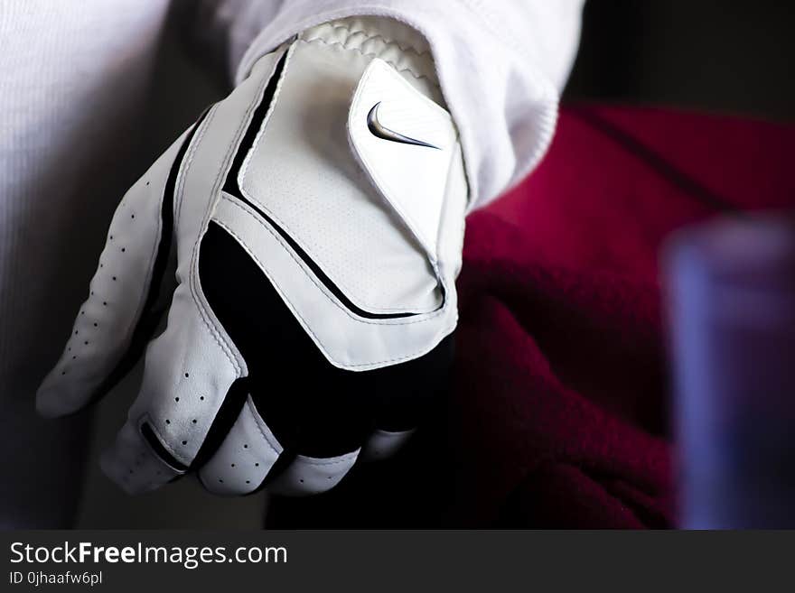 Person Wearing White And Black Nike Leather Glove