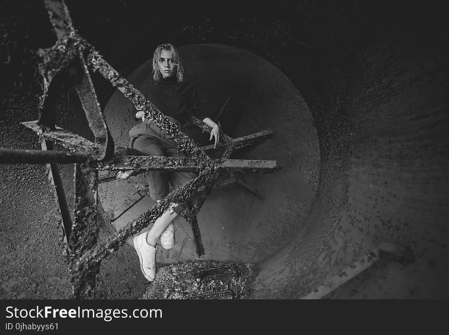 Grayscale Photography of Woman Sitting on Bar